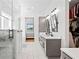 Elegant main bathroom with double vanity, sleek fixtures, glass shower, and a spacious walk-in closet at 5315 Hendrix Rd, Cumming, GA 30040