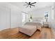 This is a bright main bedroom, featuring hardwood floors, a ceiling fan, and plenty of natural light at 5315 Hendrix Rd, Cumming, GA 30040