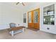Charming patio area with wood-paneled doors and a rustic wooden bench, perfect for outdoor seating at 5315 Hendrix Rd, Cumming, GA 30040