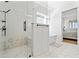 Bright bathroom featuring a frameless glass shower, tub, and hexagon tile flooring, with view into main bedroom at 5315 Hendrix Rd, Cumming, GA 30040