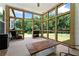 Relaxing sunroom with expansive windows and a rustic coffee table overlooks the lush backyard at 5315 Hendrix Rd, Cumming, GA 30040
