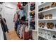 Organized walk-in closet with custom shelves, hanging racks, and shoe storage for clothing and accessories at 5315 Hendrix Rd, Cumming, GA 30040