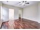 The bedroom features a ceiling fan, wood floors, and ensuite bathroom at 6470 Saint Mark Way, Fairburn, GA 30213