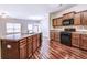 The kitchen has wooden cabinets, stainless steel appliances, and a kitchen island at 6470 Saint Mark Way, Fairburn, GA 30213