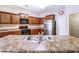 Well-equipped kitchen showcasing stainless steel appliances, granite countertops, and stylish backsplash at 6470 Saint Mark Way, Fairburn, GA 30213