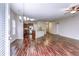 Bright living area with hardwood floors, chandelier, and view of kitchen, creating an open and inviting space at 6470 Saint Mark Way, Fairburn, GA 30213