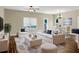 Bright and open living room with modern furnishings, wood floors, and a view of the backyard at 6470 Saint Mark Way, Fairburn, GA 30213