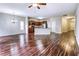 Open-concept living area with hardwood floors and seamless flow to the modern kitchen at 6470 Saint Mark Way, Fairburn, GA 30213