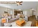 Virtually staged living room with an open concept kitchen, wood floors, and modern decor at 6470 Saint Mark Way, Fairburn, GA 30213
