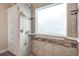 Tiled shower features a window for natural light and grab bars for accessibility at 6470 Saint Mark Way, Fairburn, GA 30213