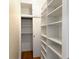 Spacious walk-in closet featuring built-in shelving units, a sliding door, and hardwood floors at 1120 Briarcliff Ne Rd # 5, Atlanta, GA 30306