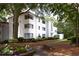 Beautiful exterior view of this home with white brick, black framed windows, and professionally landscaped grounds at 1120 Briarcliff Ne Rd # 5, Atlanta, GA 30306
