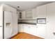 Updated kitchen with white cabinets, gray countertops, hardwood floors, and modern appliances at 1120 Briarcliff Ne Rd # 5, Atlanta, GA 30306