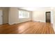 A spacious living room offers hardwood floors, neutral paint, a large window, and traditional trim at 1120 Briarcliff Ne Rd # 5, Atlanta, GA 30306