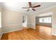 Open-concept living room and dining room featuring hardwood floors and trim, neutral paint and a ceiling fan at 1120 Briarcliff Ne Rd # 5, Atlanta, GA 30306