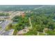 An aerial view of a neighborhood with lush greenery and proximity to local businesses and road at 2199 Clairmont Cir, Snellville, GA 30078
