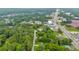 An aerial view of a property surrounded by lush trees and a road with convenient access to local businesses at 2199 Clairmont Cir, Snellville, GA 30078