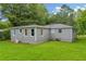 Back exterior of the home with spacious green backyard at 2199 Clairmont Cir, Snellville, GA 30078