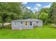 Spacious backyard with lush green grass, surrounded by mature trees and shrubbery at 2199 Clairmont Cir, Snellville, GA 30078