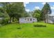 The home features a well-maintained lawn and a charming backyard setting, surrounded by lush trees at 2199 Clairmont Cir, Snellville, GA 30078