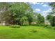 Expansive backyard with lush green grass and mature trees, perfect for outdoor activities at 2199 Clairmont Cir, Snellville, GA 30078