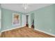 Bright bedroom featuring wood-look floors, a closet, an open door, and fresh paint at 2199 Clairmont Cir, Snellville, GA 30078
