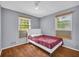 Inviting bedroom featuring neutral tones, wood-look floors, and bright, sunny windows at 2199 Clairmont Cir, Snellville, GA 30078