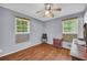 Bedroom showcasing wood-look floors, ceiling fan, and bright natural light from two windows at 2199 Clairmont Cir, Snellville, GA 30078