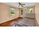 Comfortable bedroom featuring hardwood floors, natural light, and ceiling fan at 2199 Clairmont Cir, Snellville, GA 30078