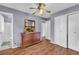 Large bedroom features wood-look floors, a TV on a dresser, closet, and adjoining bath at 2199 Clairmont Cir, Snellville, GA 30078
