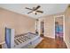 Comfortable bedroom featuring hardwood floors, natural light, and ceiling fan at 2199 Clairmont Cir, Snellville, GA 30078