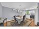 Dining area featuring hardwood floors, neutral paint, and a view into the modern kitchen at 2199 Clairmont Cir, Snellville, GA 30078