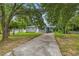 Charming single-story home with a long driveway and mature trees shading the front yard at 2199 Clairmont Cir, Snellville, GA 30078