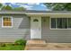 Close-up of the home's front door, showing the clean white door, siding, and well-kept landscaping at 2199 Clairmont Cir, Snellville, GA 30078