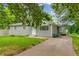 Charming single-story home with a well-maintained lawn, siding, and a cozy seating area on the driveway at 2199 Clairmont Cir, Snellville, GA 30078