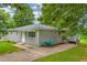 Charming single-story home with a well-maintained lawn, siding, and a cozy seating area on the driveway at 2199 Clairmont Cir, Snellville, GA 30078