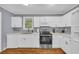 Modern kitchen features white cabinets, stainless steel appliances, and ample counter space for cooking at 2199 Clairmont Cir, Snellville, GA 30078