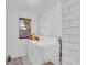 Bright laundry room with white subway tile, a window, and a modern washer and dryer at 2199 Clairmont Cir, Snellville, GA 30078