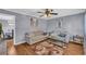 Cozy living room featuring hardwood floors, neutral paint, comfortable couches, and a stylish area rug at 2199 Clairmont Cir, Snellville, GA 30078