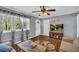 Bright living room showcasing large windows, hardwood floors, neutral paint, ceiling fan and cozy decor at 2199 Clairmont Cir, Snellville, GA 30078