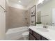 Cozy bathroom with a combined tub and shower, single vanity, and neutral tile work at 3442 Fishpond Cir, Dacula, GA 30019