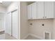 Practical laundry room with tile flooring and white cabinets for ample storage space at 3442 Fishpond Cir, Dacula, GA 30019