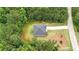 An aerial view of a home with a long driveway surrounded by lush trees at 509 Grace Ln, Villa Rica, GA 30180