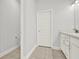Bathroom featuring tile flooring, white cabinets, and a toilet in an alcove at 509 Grace Ln, Villa Rica, GA 30180