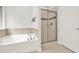 Bathroom area featuring a garden tub and glass shower at 509 Grace Ln, Villa Rica, GA 30180