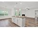 Open living space showcasing a center kitchen island and cozy fireplace at 509 Grace Ln, Villa Rica, GA 30180
