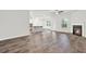 Spacious living area with a cozy fireplace, modern lighting, and access to the kitchen at 509 Grace Ln, Villa Rica, GA 30180