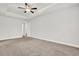 Spacious main bedroom featuring tray ceiling, fan and ensuite bathroom entrance at 509 Grace Ln, Villa Rica, GA 30180