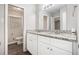 Bright bathroom with double granite vanity, modern fixtures, and updated flooring at 637 Carlouetta Sw Rd, Mableton, GA 30126