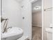 Tidy bathroom featuring a sleek sink, tiled wall, and access to a separate room at 637 Carlouetta Sw Rd, Mableton, GA 30126